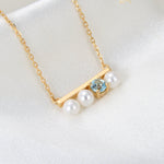 Lamorvita_PearlBlueTopaz_Bar_SilverNecklace_LeftScene